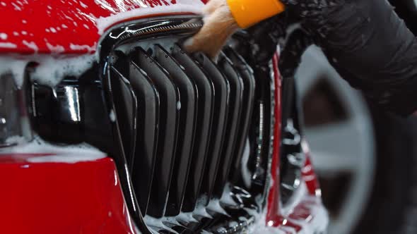 Auto Cleaning Service  a Man Worker Cleaning Small Details of a Car Using a Brush alt
