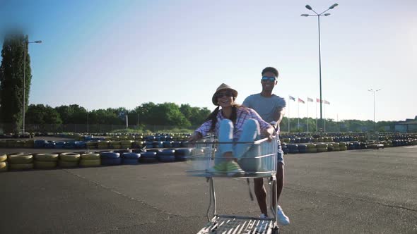 Young Friends Having Fun on Shopping Trolleys alt