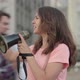 Young Eco-activist Shouting Through Megaphone and People with Banners Joining Leader in - VideoHive Item for Sale