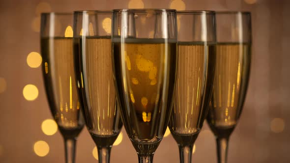 champagne glasses over Holiday Bokeh Blinking background alt
