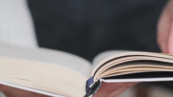 Reading a Book and Turning the Pages Close Up Slow Motion alt