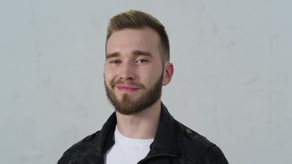 Young Man Turning His Head and Looking at the Camera and Smiling