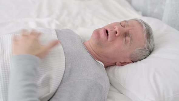 Senior Old Man Sleeping in Bed and Having Chest Pain alt