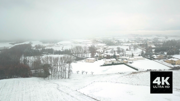 Fast Motion Aerial View Over Snowy French Countryside