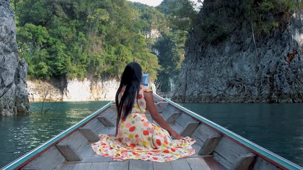 Khao Sok Thailand Woman on Vacation in Thailand Girl in Longtail Boat at the Khao Sok National Park alt
