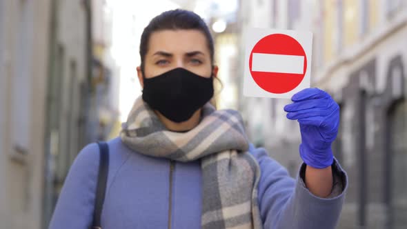Woman in Face Mask with Stop Sign in City alt