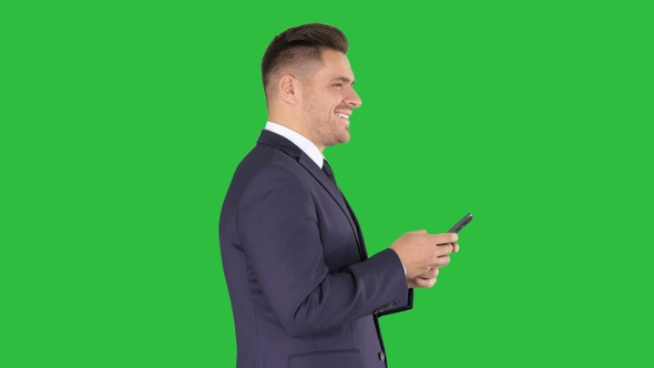 Mature businessman using mobile phone texting message on alt