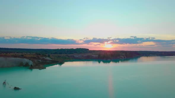 An artificial lake in chalk quarry. view from drone. Turquoise water background alt