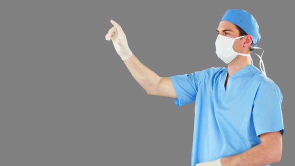 Surgeon pretending to be using futuristic digital screen alt