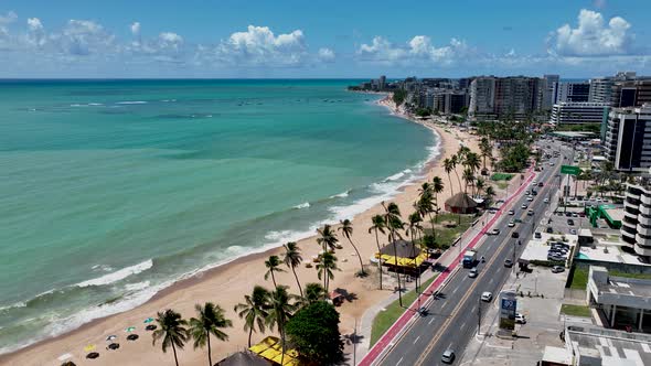 Aerial panning shot of turquoise water beach at Maceio Alagoas Brazil. alt