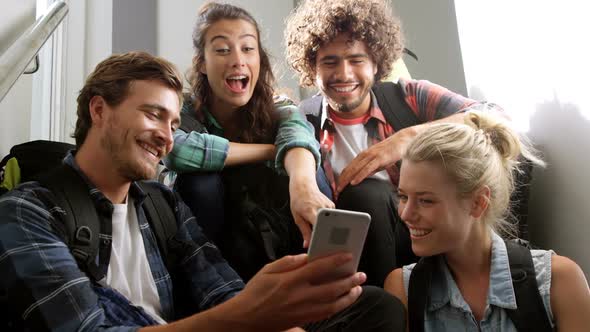 Man showing mobile phone to his friends alt