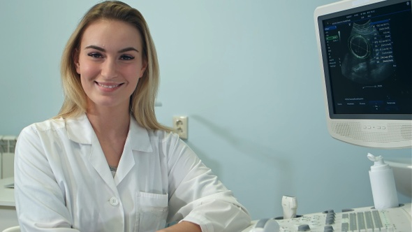Smiling female doctor looking into the camera and taking