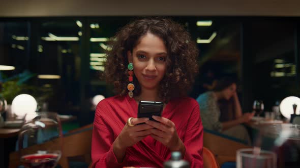 Sexy Girl Surfing Mobile Phone on Dinner Date alt