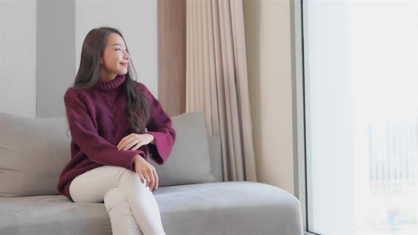 Asian woman sit on sofa and relax alt