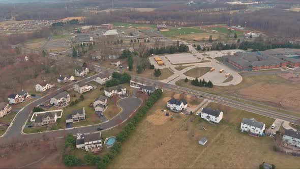 Aerial View on the Residential Streets Landscape Early Spring of a Small Town Near Yellow School alt
