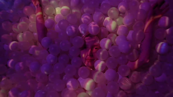 Young Woman Playing with Balls in a Dry Pool Spotlight with Abstract Art Digital