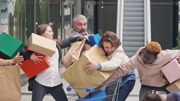 Group of Shopaholics With Shopping Bags Are Pushing at Store. Crazy Shopping at Big Sales alt