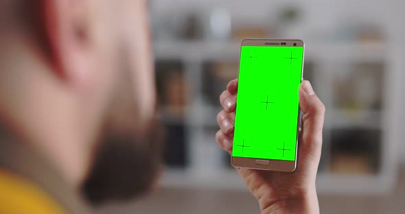 Smartphone with Green Screen in Male Hands