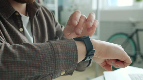 Close-up of Guy's Hand Swiping Digital Watch Screen Checking Messages with Smart Device alt