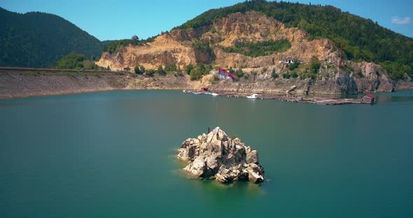 Serbian flag waving on a pole at a lonley island in the middle of Zaovine lake, Tara mountain