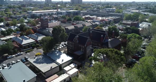 Original school facade under construction revealing Melbourne CBD and commission towers. alt