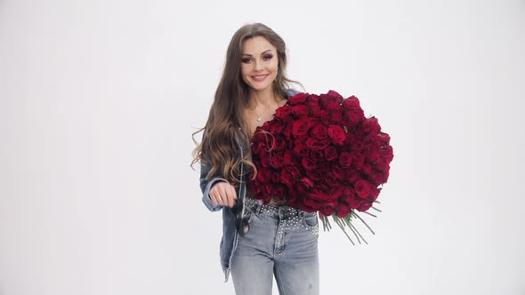 Attractive Woman Going to Camera with Bouquet of Red Roses