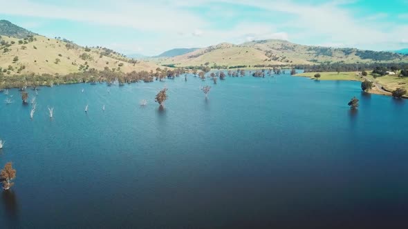 Rising aerial footage of the swollen floodplains of the Mitta Mitta River near where it enters Lake alt
