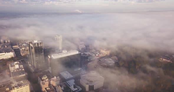 Flying Over The City on a Foggy Morning