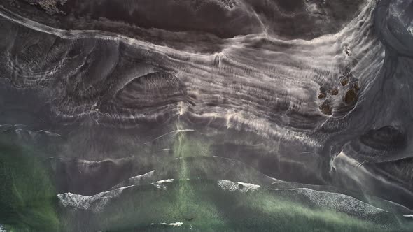 Aerial view of abstract pattern created by a red sand beach, Faroe island. alt