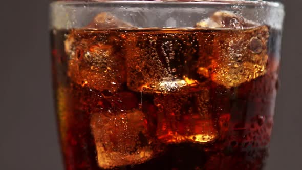 Carbonated Drink Cola in a Glass Glass with Ice
