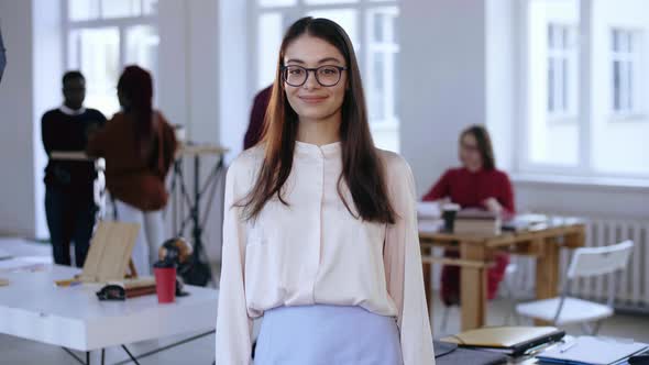 Medium Portrait of Beautiful Young Smart Brunette Business Woman in Eyeglasses Looking at Camera in alt