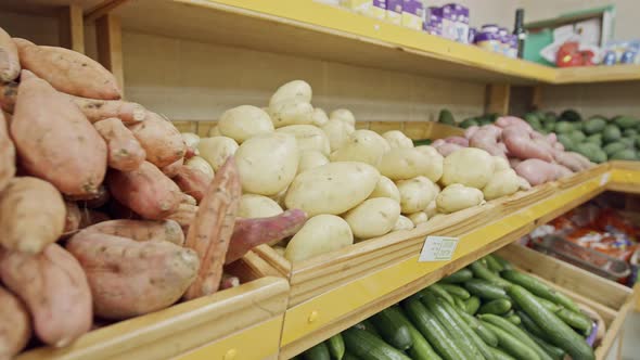 Large variety of vegetables and fruits on a supermarket shelves alt
