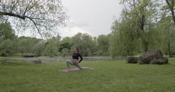 Young Sportswoman Doing Yoga in the Park alt