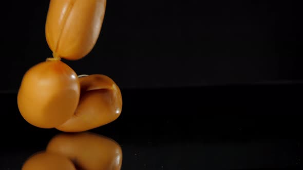 Person Hand Puts Delicious Sausages Reflecting Bright Light alt