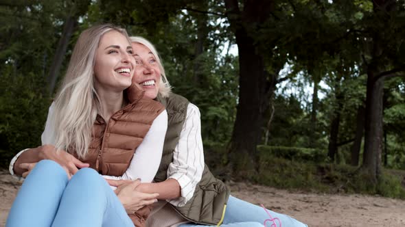 Two Happy Women Sitting and Enjoying View alt