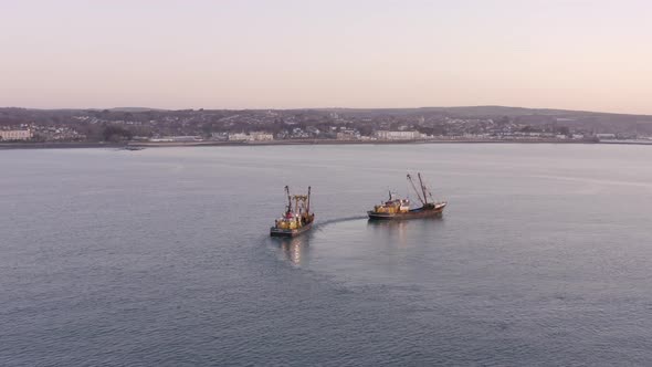 Fishing Trawlers at Sunrise Seen From the Air alt