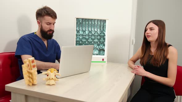 Female Patient Talking to Male Therapist in Clinic alt