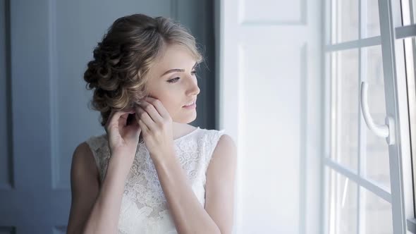 Beautiful Bride Puts on Earring alt