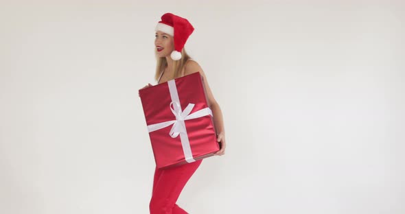 Smiling Pretty Woman Holding Big Gift Box on Christmas Eve