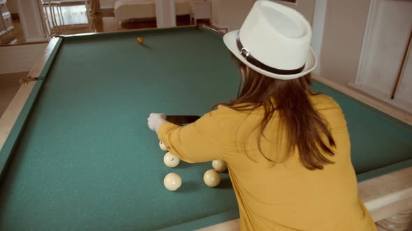 Woman in a Hat Put Billiard Balls Into A Triangle For A New Game