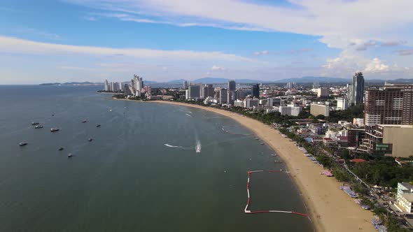 Sliding aerial view of Pattaya Beach and cityscape alt