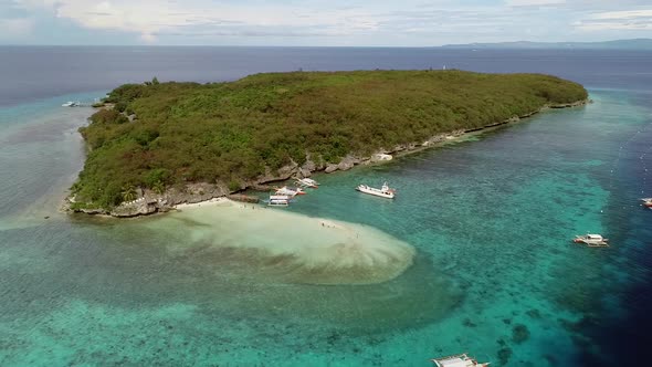 Aerial view of Sumilon Island and outrigger boats, Philippines. alt