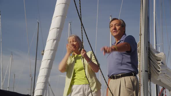 Senior couple on sailboat together. Shot on RED EPIC for high quality 4K, UHD, Ultra HD resolution. alt