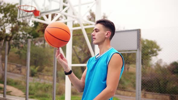 Portrait of a Basketball Player Spinning a Basketball on the Street Playground alt