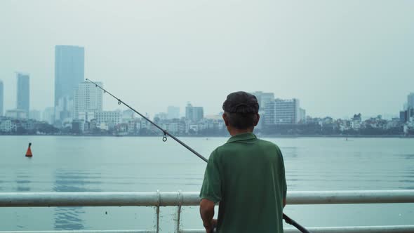 Handheld view of senior man fishing. Shot with RED helium camera in 8K alt