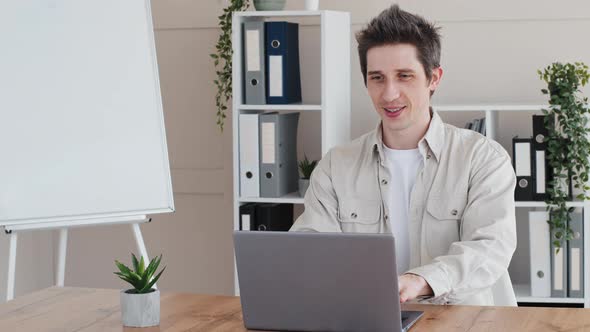 Caucasian Millennial 30s Man Guy User Freelancer Manager Office Worker Sits at Table Typing on alt