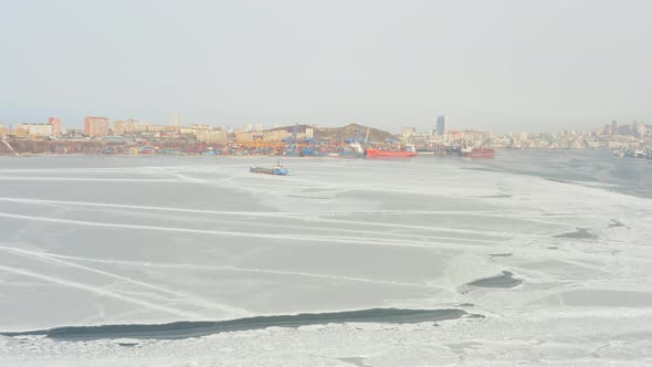 The Piers of the Peninsula with Moored Ships and the Icecovered Sea alt