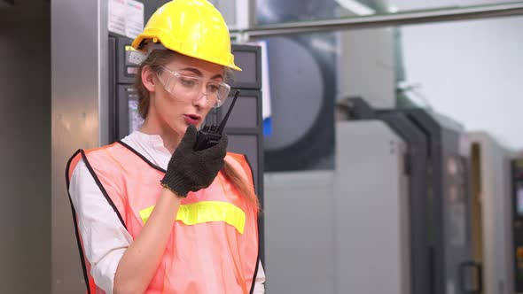 Serious female engineer worker calling and talking to colleague