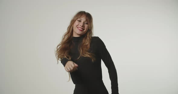 Young Red Headed Woman In Black Dancing