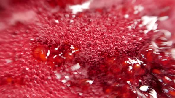 Raspberry syrup. Pink background with bubbling bubbles and raspberries. alt